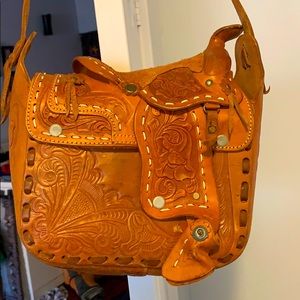 This is a hand made leather horse saddle purse.